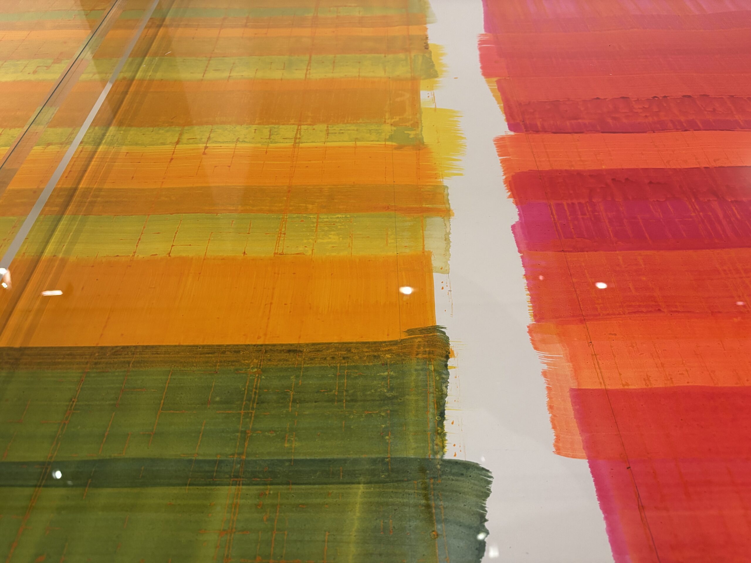 An abstract background image of swathes of colour, mostly red and orange.